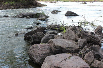 Fototapeta na wymiar River with large granite stones. Steppe. Nature
