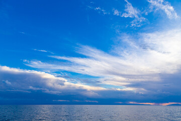 Fototapeta na wymiar Bright cumulus clouds against the blue sky. Sunset sky Natural background.