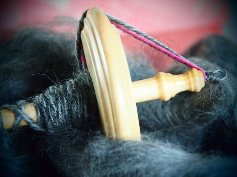 Close-up Of Drop Spindle And Wool