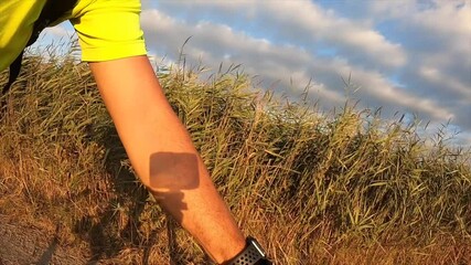 Left arm on a bicycle on a sunrise landscape while sun shining while travelling in motion