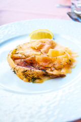 grilled salmon and lemon - french cuisine dish with tomato and salmon
