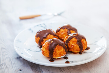 Profiterole with vanilla and chocolate sauce