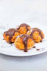 Profiterole with vanilla and chocolate sauce