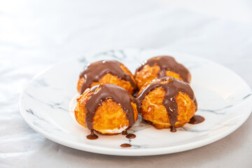 Profiterole with vanilla and chocolate sauce