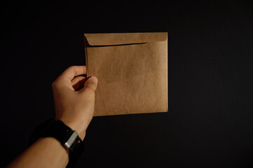 Man holding brown envelope