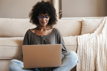 Young afro american woman using laptop