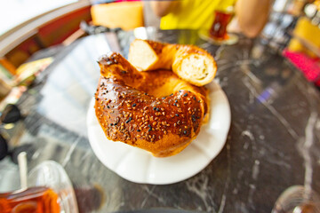 Traditional street food, crispy sesame bread ring bagels. Greek koulouri or Turkish bagels called Simit in stack with chocolate.