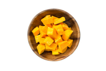 Pieces of pumpkin in a wooden saucer on a white background. View from above