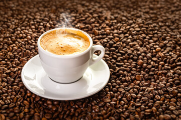 Cup with coffee on the background of coffee beans