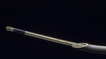 Macro-photography of epidural catheter appearing from 18G Tuohy epidural needle's tip. - obrazy, fototapety, plakaty