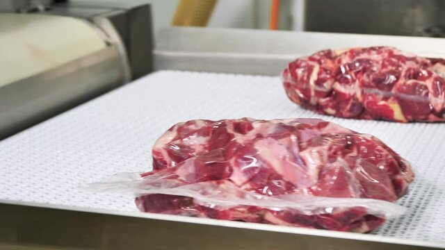 Vacuum packing line for meat pieces. Meat processing plant
