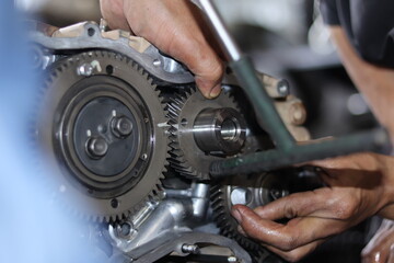 The mechanic is checking the engine.