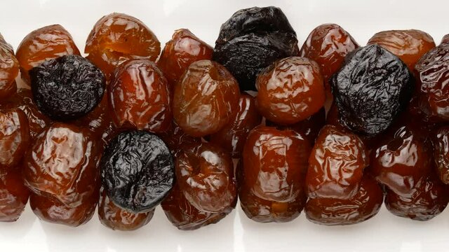Dried fruits on a plate. Prunes and dates.