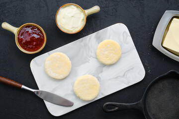 Top view of fresh cheese pancake on marble serving board