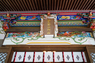 Japanese colorful shrine architecture. Japanese text on center sign is 