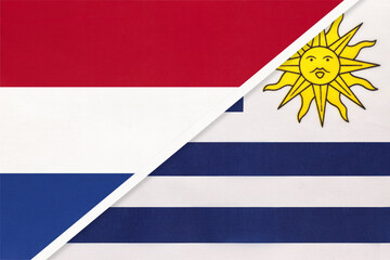 Fototapeta premium Netherlands or Holland and Uruguay, symbol of national flags from textile. Championship between two countries.