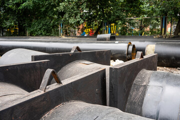 Closeup view of two new insulated water pipes on city road in summer day. Urban sewerage infrastructure concept, modernization and reconstruction of underground water system.