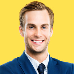 Portrait image of confident businessman in blue suit and tie, isolated against yellow background. Business success concept. Smiling man at studio picture. Square composition.