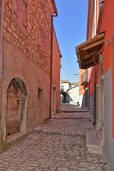 Fototapeta na wymiar A narrow street among the old houses of Sepino, a medieval village in the Molise region.