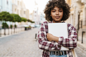 Pretty young african woman walking outdoors