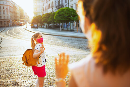 Mom And Child Say Goodbye Before Going To School Outdoors