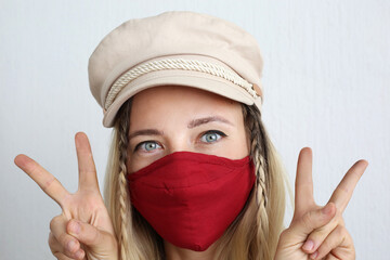 Woman wearing face mask decorated with flowers. Stylish handmade cotton mask.	