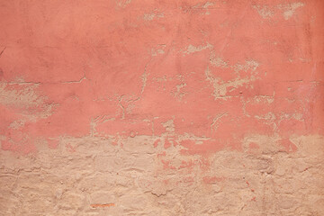 Abstract pink background texture from weathered cement and plaster wall