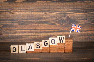 GLASGOW. City in Great Britain. Steps and flag on a wooden background