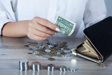 girl counts money on the table with coins.