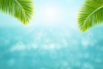 Fototapeta na wymiar Summer Vacation and Holiday Trip Concept : Green leaves of coconut tree with blurry image seascape view and blue sky in background.