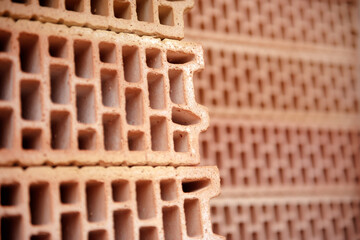 Close-up of an orange clay stone for house building with insulating air chambers.