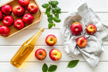 Top view of apple cider or vinegar - bottle with ripe fruits and leaves