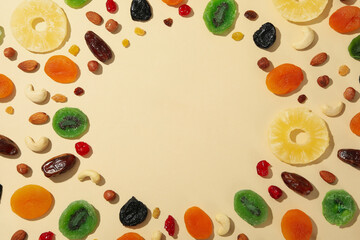 Tasty dried fruits on beige background, space for text