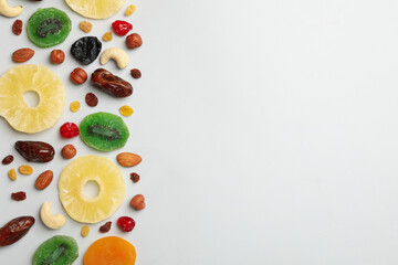Nuts and dried fruits on gray background, top view