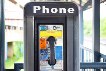 Vintage, retro public coin-operated telephone. Phone booth with old fashioned phone.