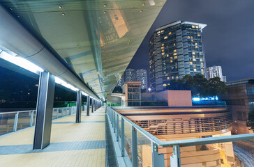 Modern pedestrian walkway in midtown of Hong Kong city at night