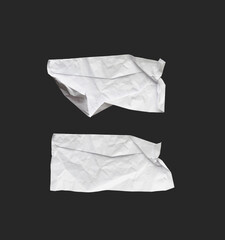 Obraz premium White ripped note, notebook paper stuck with sticky tape on black background.