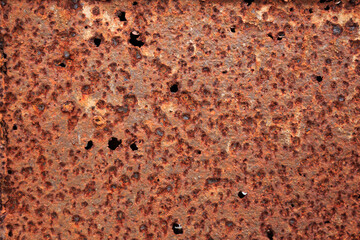 The iron is rusty, indented.