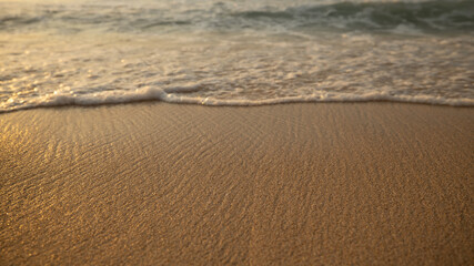 Scenic seascape. Milky foam waves at the beach. Sunset time. Waterscape for background. Selected soft art focus. Sunlight reflection on the water and sand. Copy space. Balangan beach, Bali, Indonesia