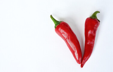 Two hot chili peppers on white isolated background