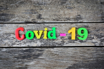 Covid-19 word on a wooden table