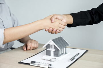 Fototapeta na wymiar hands shaking after Real estate agents explains a business contract, lease, purchase, mortgage, loan, or home insurance to buyer