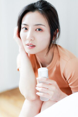 Asian women with skin lotion