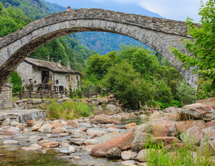  A romanesque bridge made of donkey back of of the 17th century, at the entrance to the village of Fondo ,in Piedmont,Italy