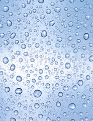 Water drops over light blue surface