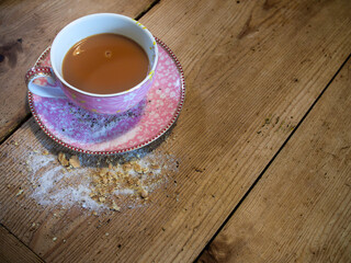 hot cup of tea on moody wood table, looking down view of cup of tea.