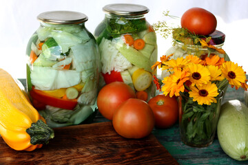 Pickles in glass jars. Home canning of vegetables.