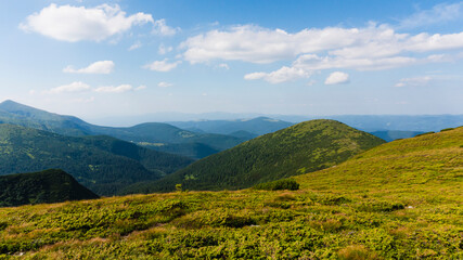 Amazing mountain landscape with blue sky with white clouds, sunny summer day in Carpathians, Ukraine.