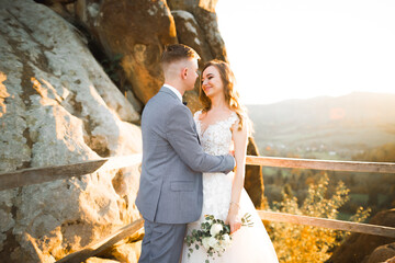 Gorgeous happy couple standing close to each other and looking in eyes