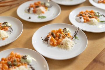Smoked Salmon Topped with Capers, Cheese, Seeds and Sauce. Gourmet cuisine, luxury catering.